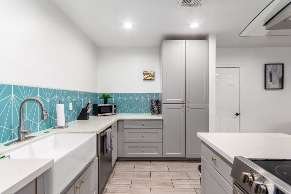 Cook and connect in the modern kitchen, featuring an elegant island and ample seating for family and friends.