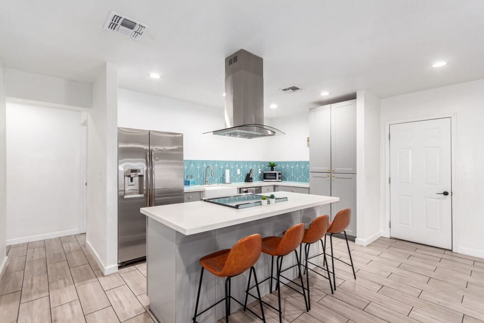 Cook and connect in the modern kitchen, featuring an elegant island and ample seating for family and friends.