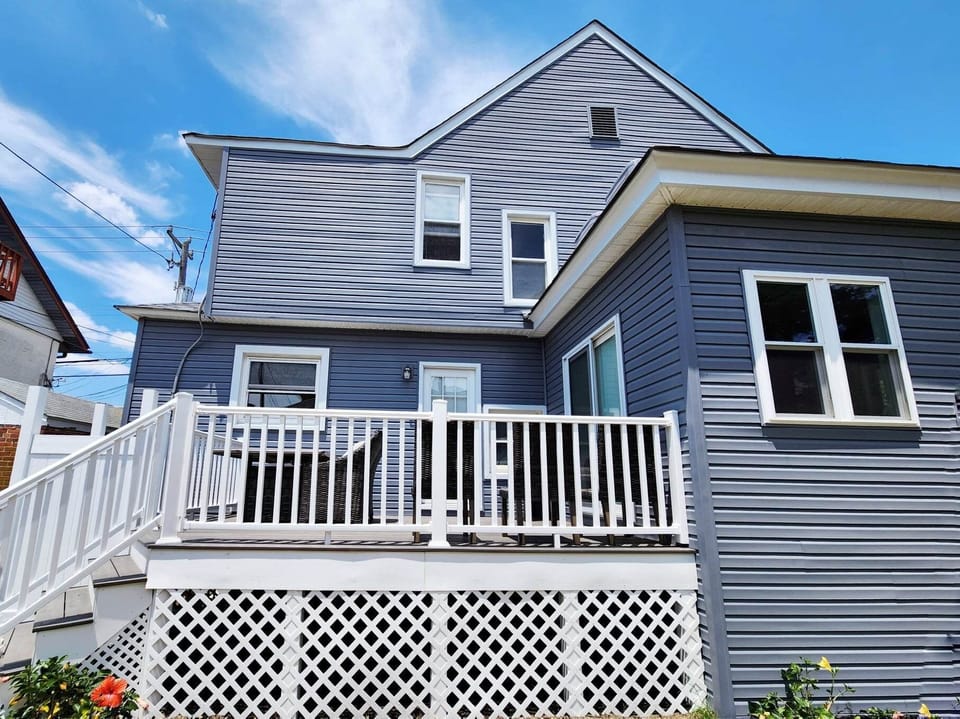 Back view of house, with private deck and backyard