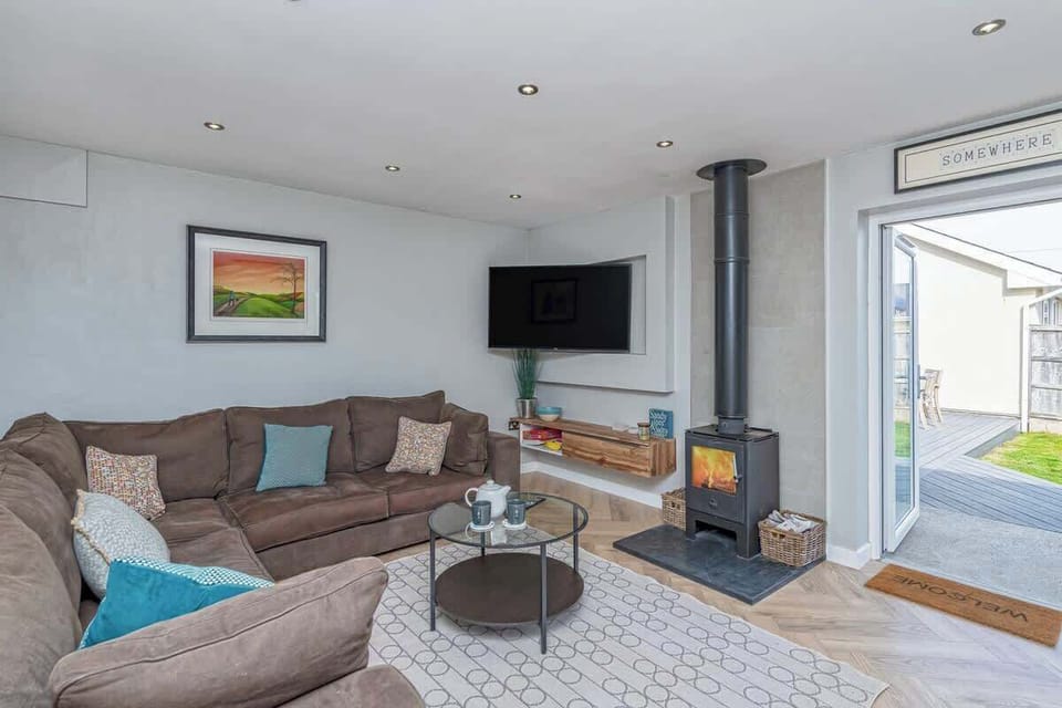 Spacious living room with wood burner