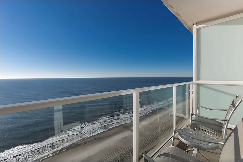 Sip morning coffee on your balcony above endless ocean views.
