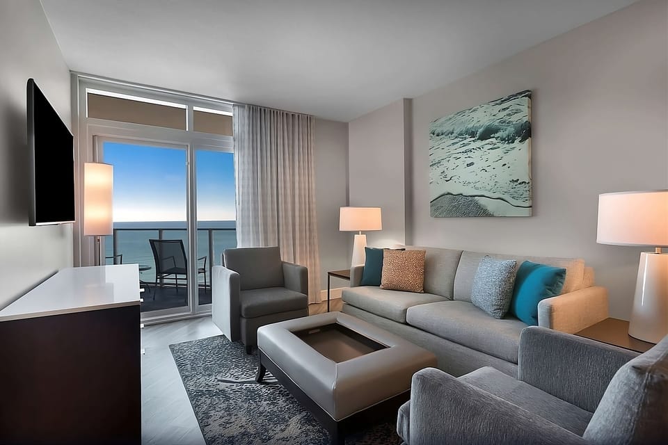 Unwind on plush seating with soothing sea views beyond.