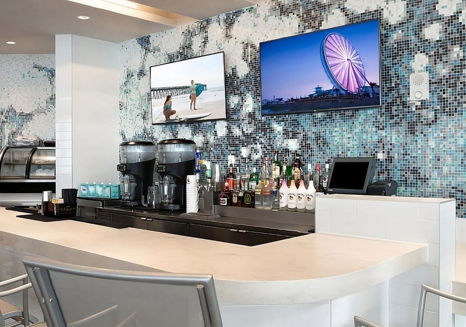 Enjoy a polished bar setup with curated spirits and screens.