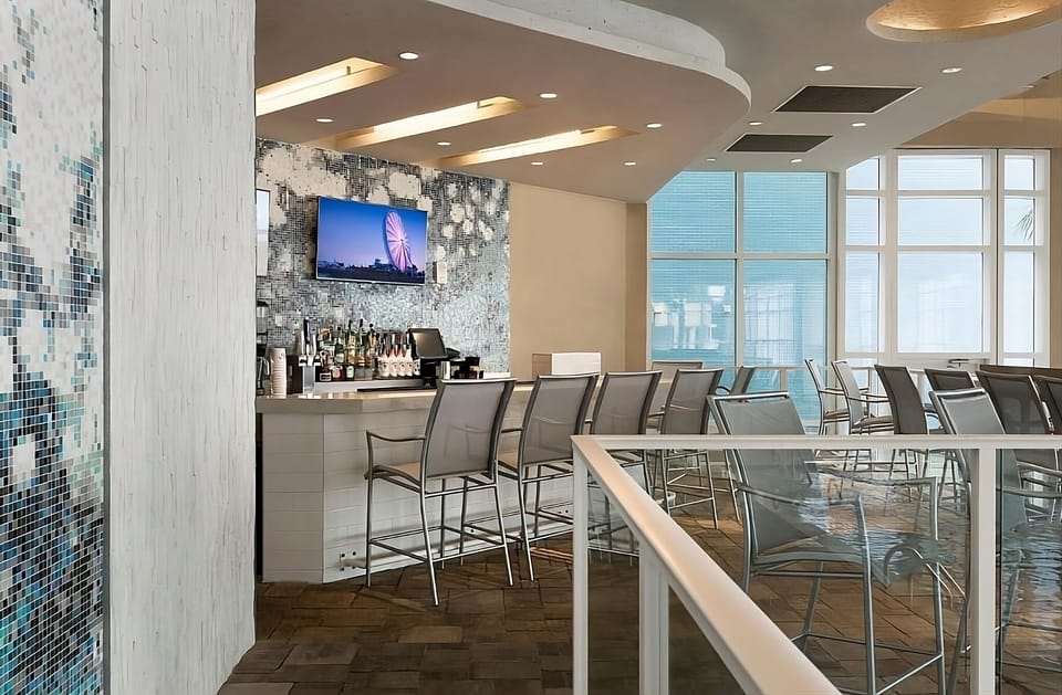 Sip cocktails at the sleek bar with airy, sunlit views.