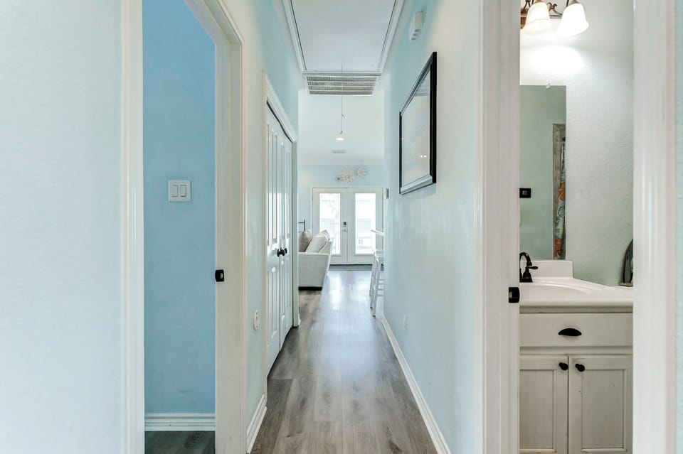 Charming Hallway: Light blue walls create a serene passage leading to your beach getaway!