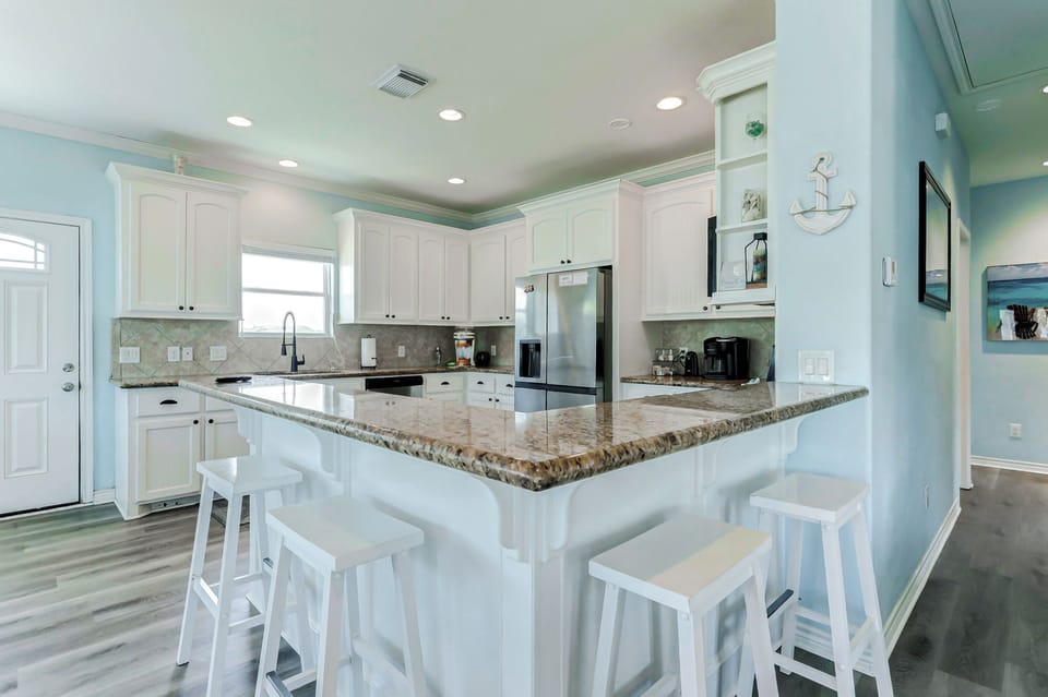 Fully Equiped Kitchen: Whip up seaside meals in this bright, airy space with sleek finishes!