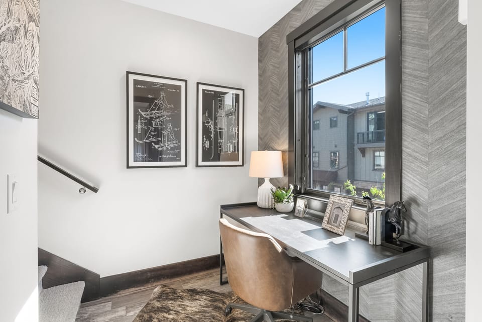 - Work remotely in a quiet desk nook with natural light and décor  
- Comfortable chair and desk setup perfect for productivity  
- Charming accents and framed artwork create an inspiring corner