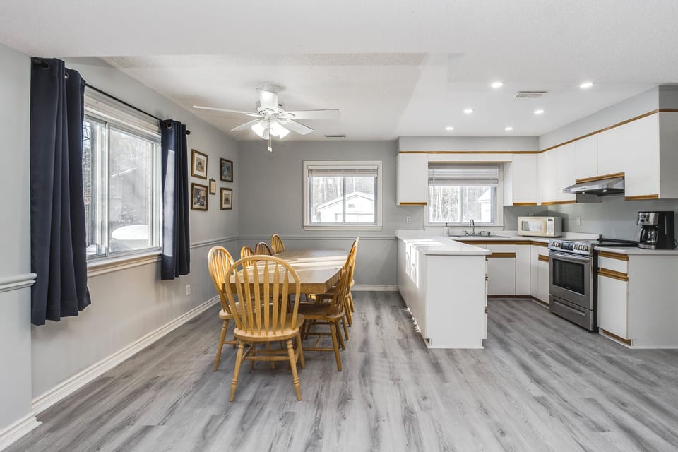 Bright open-concept kitchen and dining area with abundant natural light