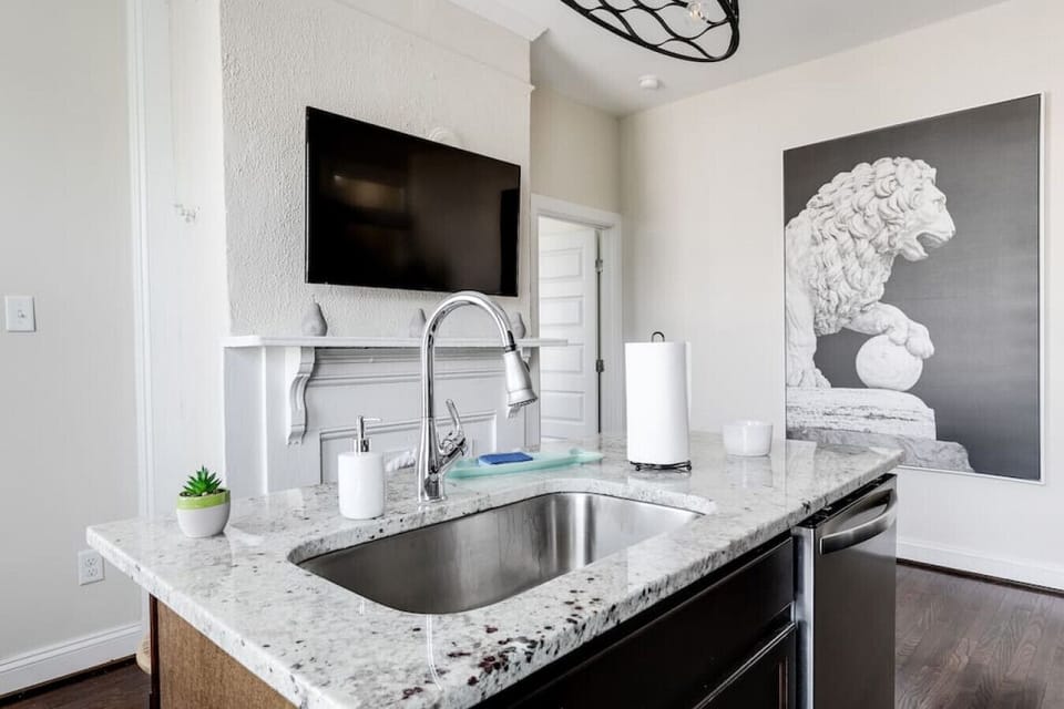 Bright, fully equipped kitchen with island seating for four, a flat‑screen TV for mealtime entertainment, full‑size fridge and freezer, oven, stove, microwave, Keurig, toaster, and all the essentials you need to cook comfortably during your stay.