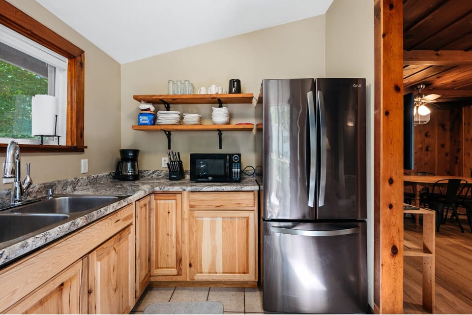 Kitchen: Whip up culinary delights with modern appliances and nature views just outside the window!