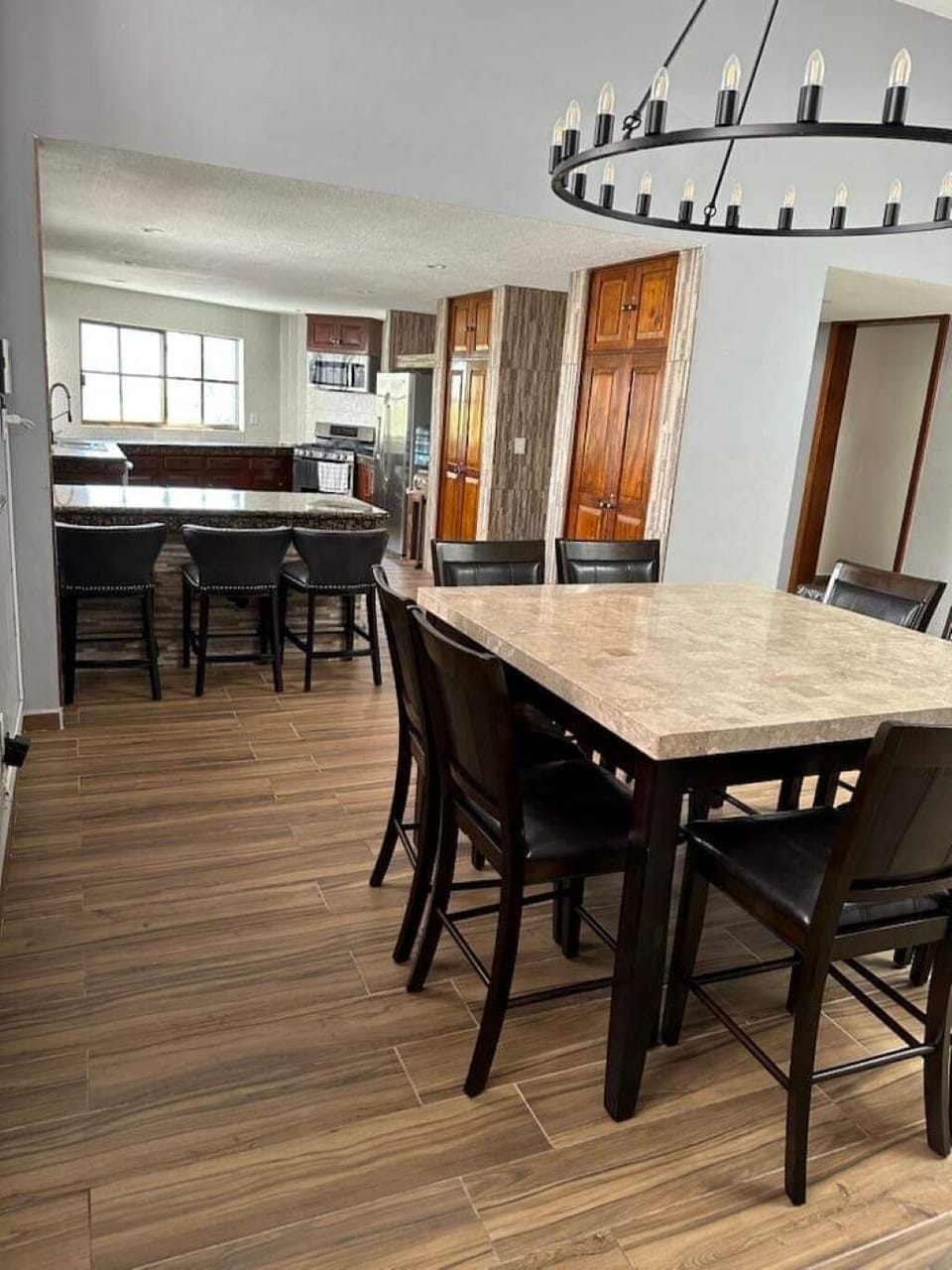 Kitchen w/stools, stainless steel appliances, granite counters,  and ocean views