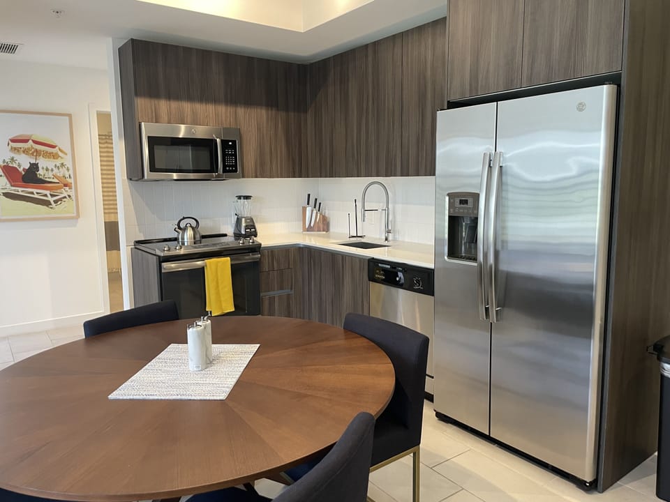 Full Kitchen with coffee maker, blender, utensils and cookware 