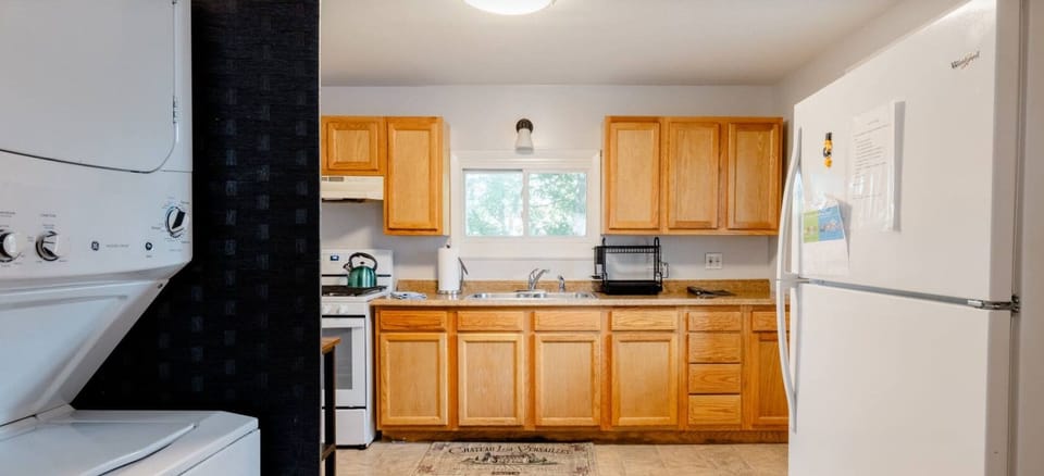 Entering the kitchen is the refrigerator and washer dryer left. 