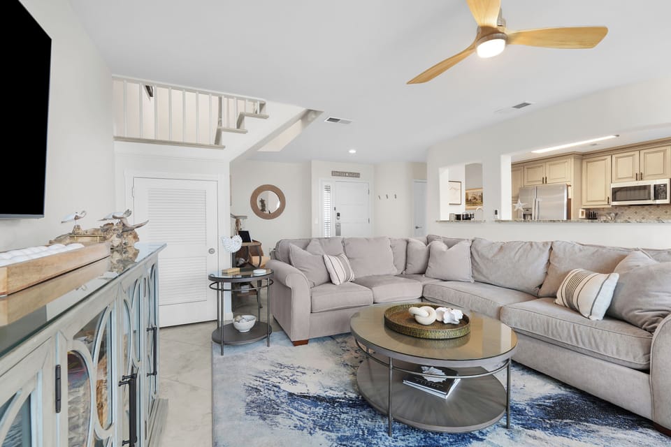 Gorgeous Oceanfront Living Space with Comfortable Sectional Sofa, Two Swivel Glider Chairs and Flat Screen Smart TV