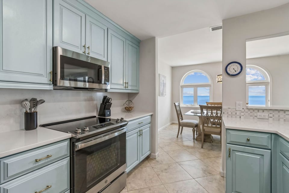 Newly Renovated Kitchen with Quartz Countertops and Stainless Steel Appliances - Kitchen is Open to Living and Dining Spaces