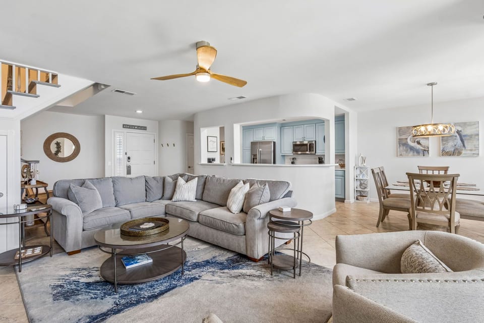 Gorgeous Oceanfront Living Space with Comfortable Sectional Sofa, Two Swivel Glider Chairs and Flat Screen Smart TV