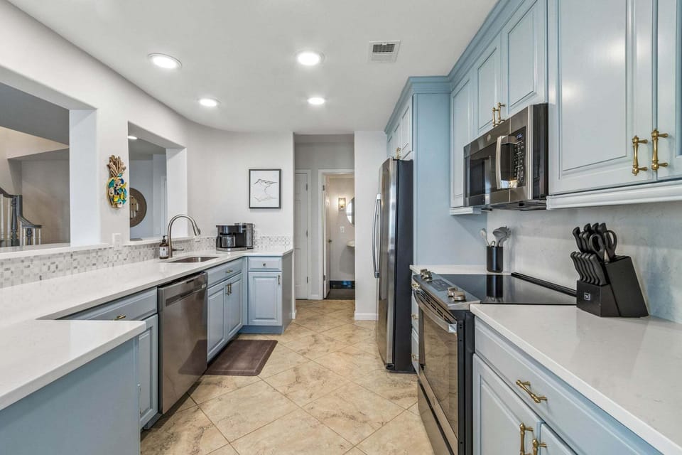 Newly Renovated Kitchen with Quartz Countertops and Stainless Steel Appliances - Kitchen is Open to Living and Dining Spaces