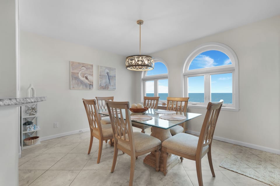 Oceanfront Dining Space with Glass Topped Table Seating Six