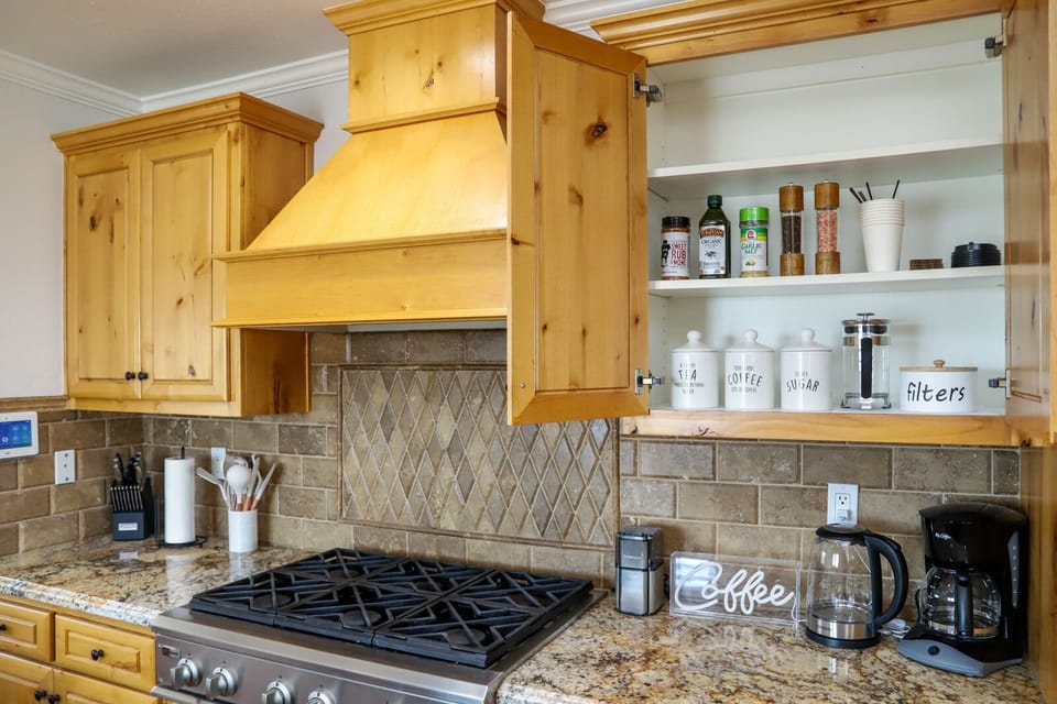 Kitchen stocked with necessities: pots/pans, toaster, crock pot, blender