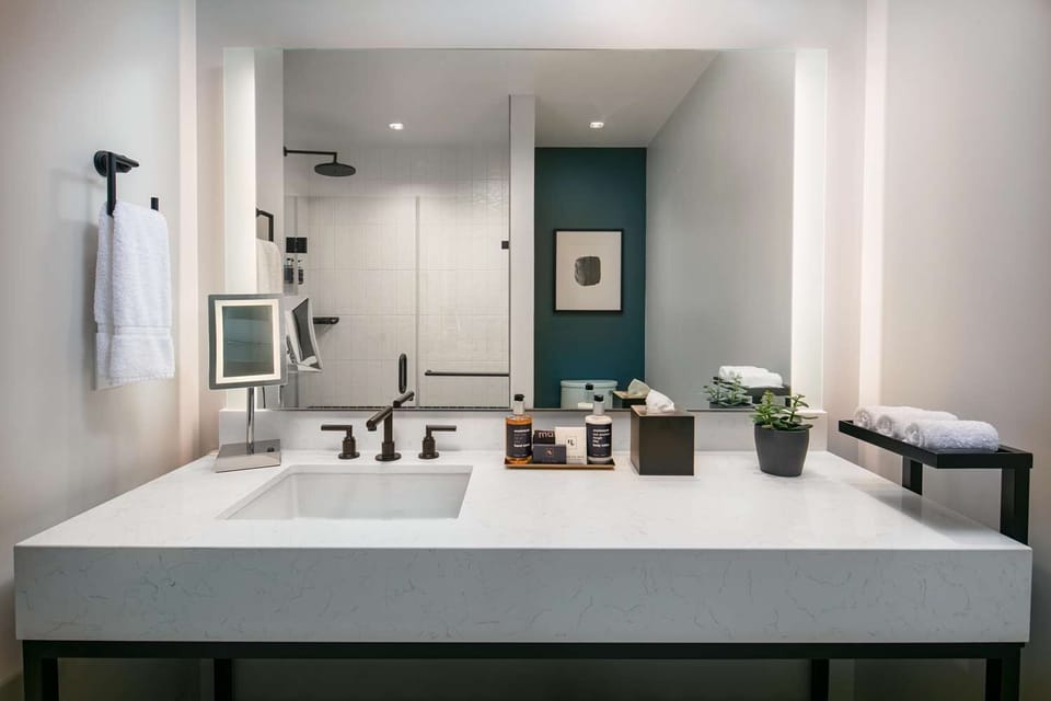 Get ready in style with a wide vanity and bright mirror.