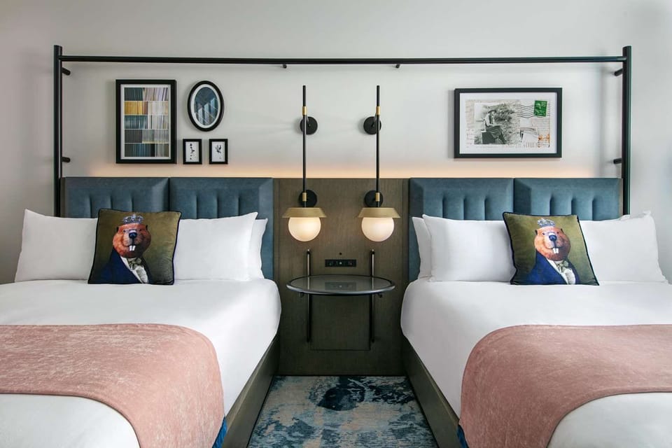 Drift off between two cozy beds with soft ambient glow.