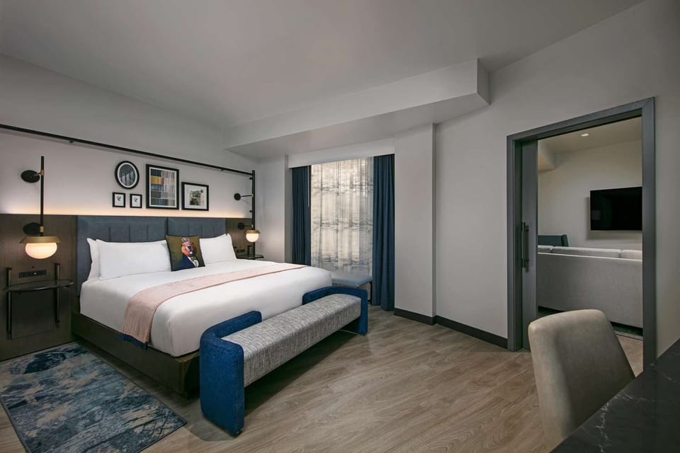 Recharge in a quiet corner bedroom with soft lighting.