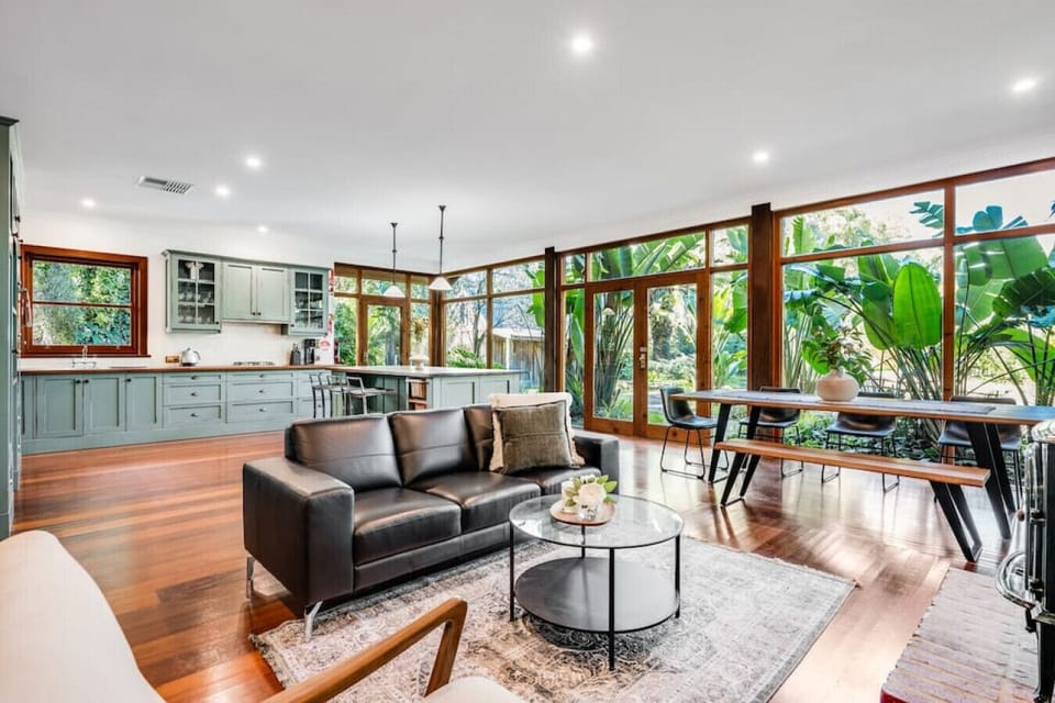 This living room masterfully blends warm wooden elements with sleek modern design, creating a space that feels both inviting and sophisticated. Natural textures, minimalist lines, and soft lighting work together to create an atmosphere of understated eleg