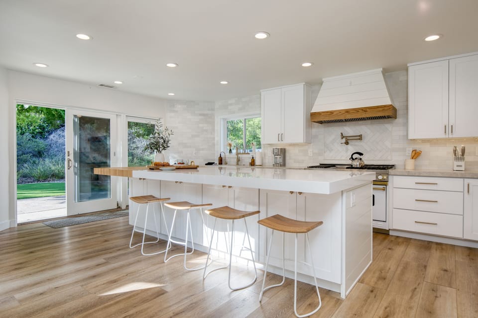 Bright and chic kitchen is fully equipped with everything you need.