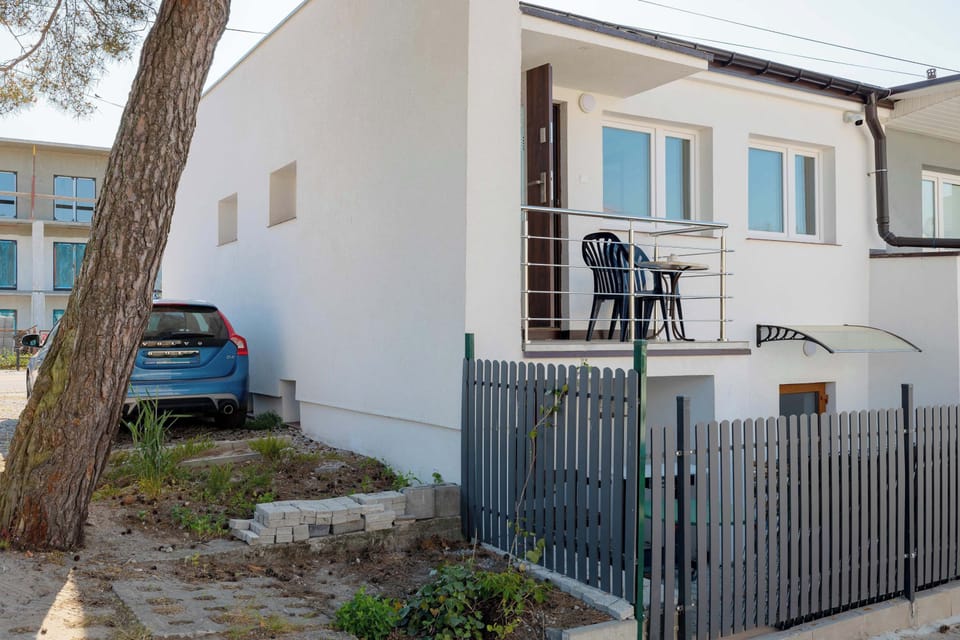 Street view of the balcony tucked at the end of the building.