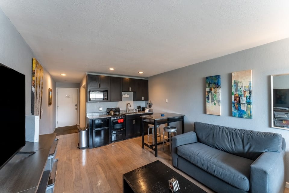 Relax in your modern suite with sleek kitchen, cozy seating, and stylish décor—everything you need for a comfortable stay.