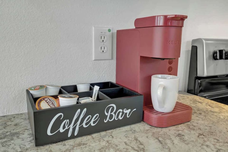 The coffee bar features a keurig and coffee pods. 