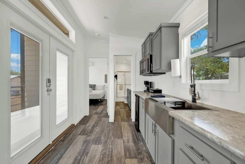 The kitchenette features a mini-fridge, keurig coffee maker, microwave and sink.  