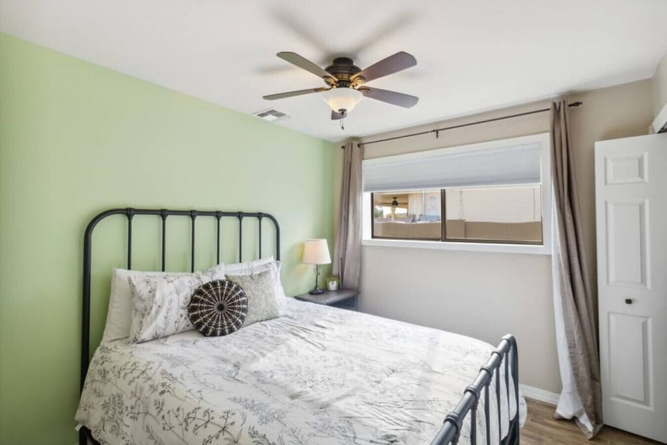 Guest bedroom with cozy bed, closet storage, and natural light