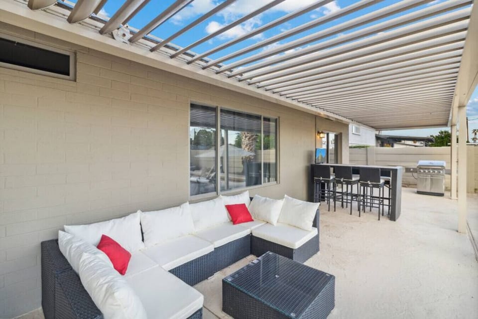 Covered patio with outdoor lounge seating and dining area