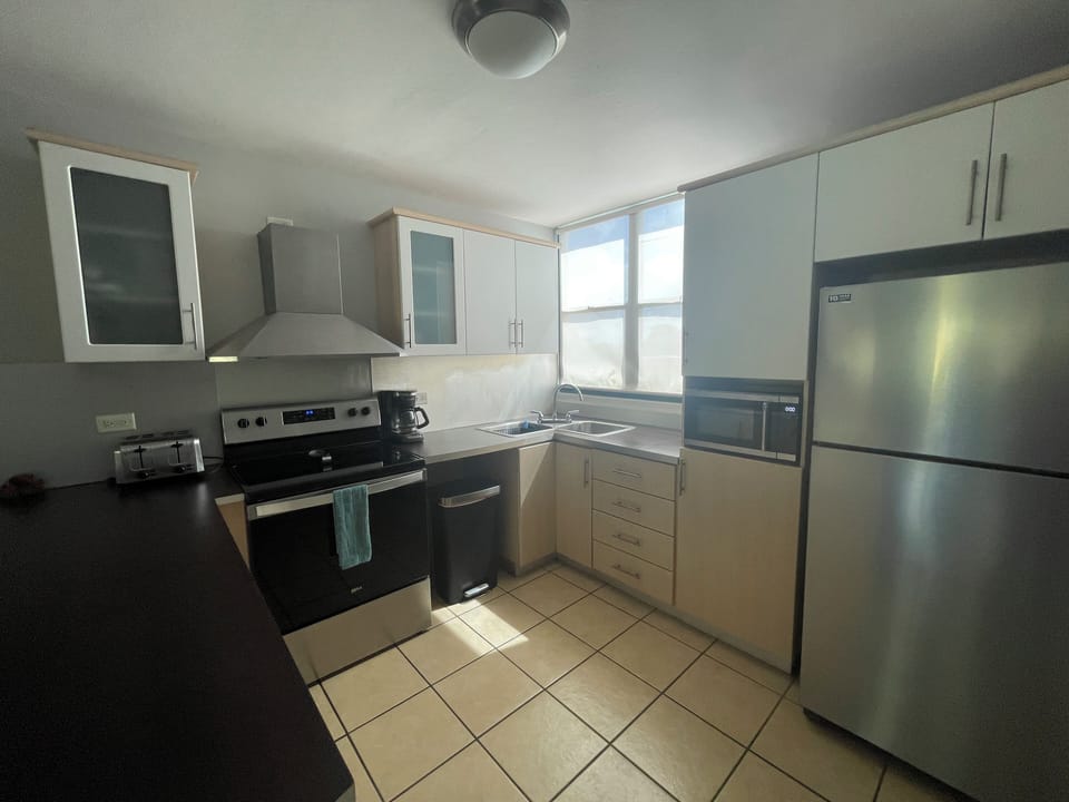 Kitchen with full size appliances, pots, pans and utensils.