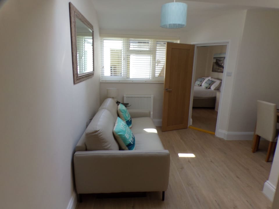Lounge/Dining room with luxury sofa bed.