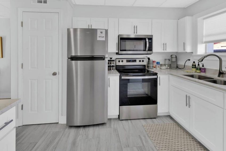 Stainless Steele appliances are a must in this grand space! 
