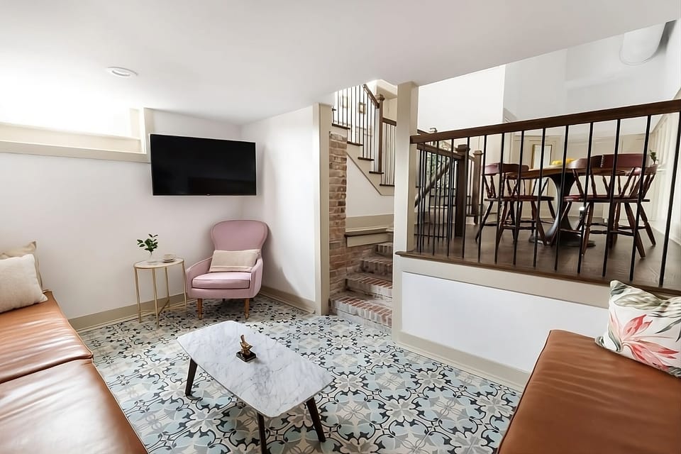 Kick back on the sofa with TV and patterned tile floors.
