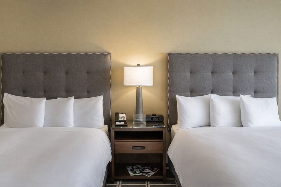 Drift off on cloud-soft linens under warm bedside glow.