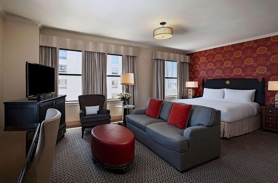 Unwind in a spacious suite with sofa and sunny windows.