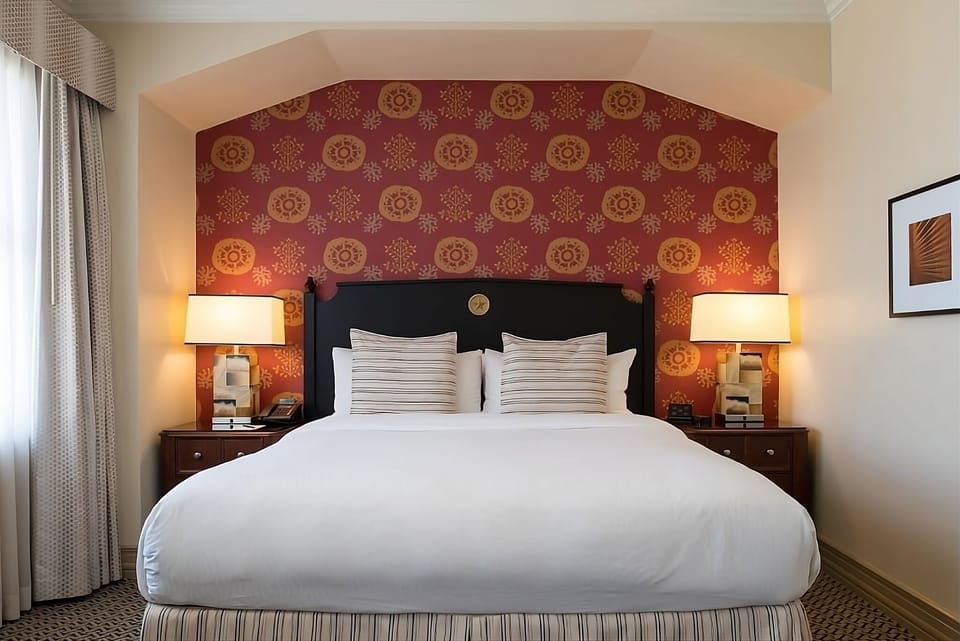 Sink into crisp linens framed by warm, welcoming bedside glow.