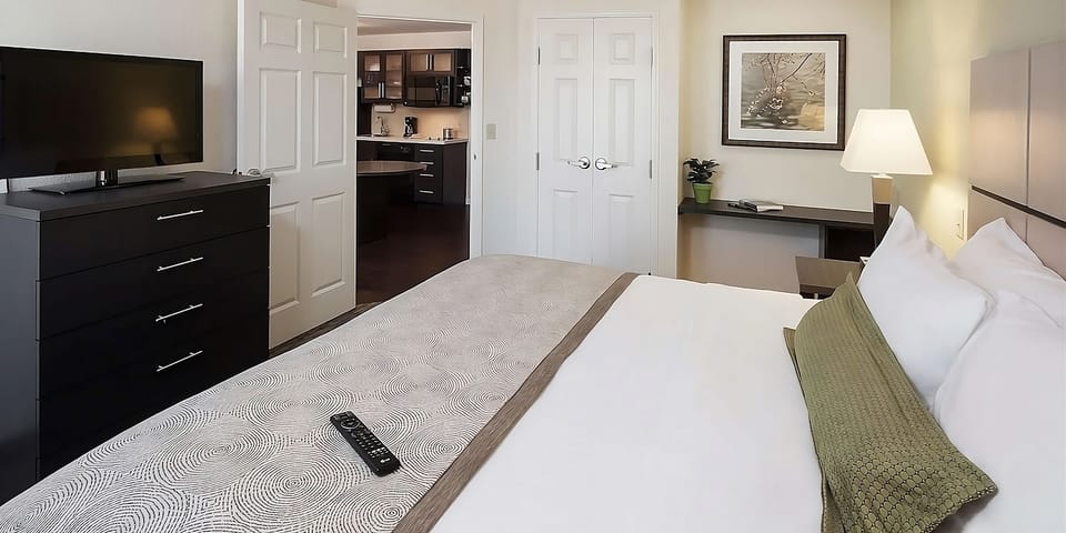 Settle in with plush bedding, TV entertainment, and easy kitchenette access.