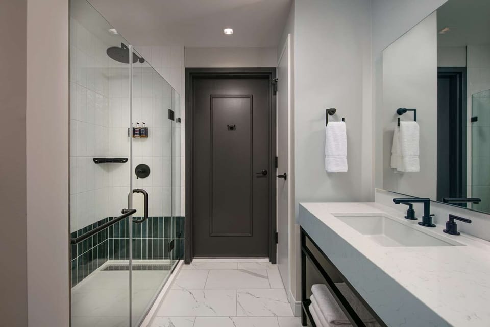 Refresh under a sleek walk-in shower after city adventures.