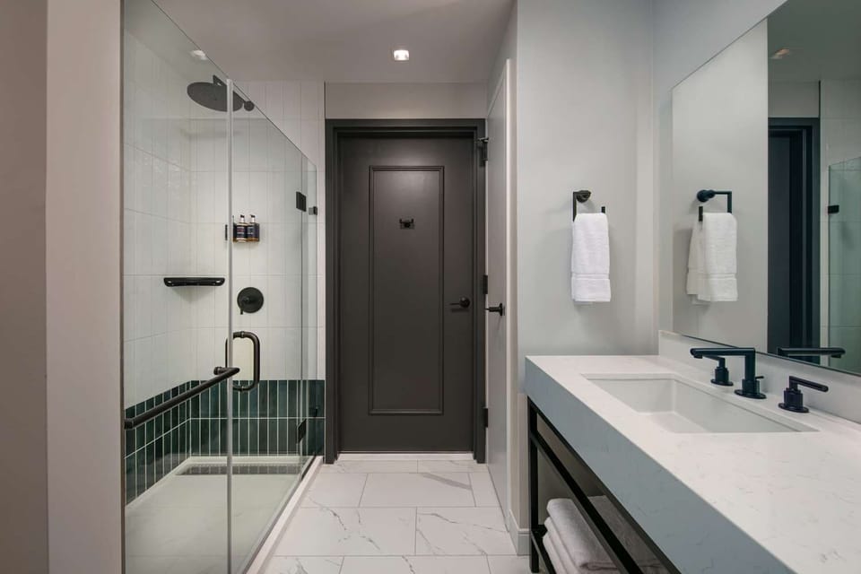 Refresh under a sleek walk-in shower after city adventures.