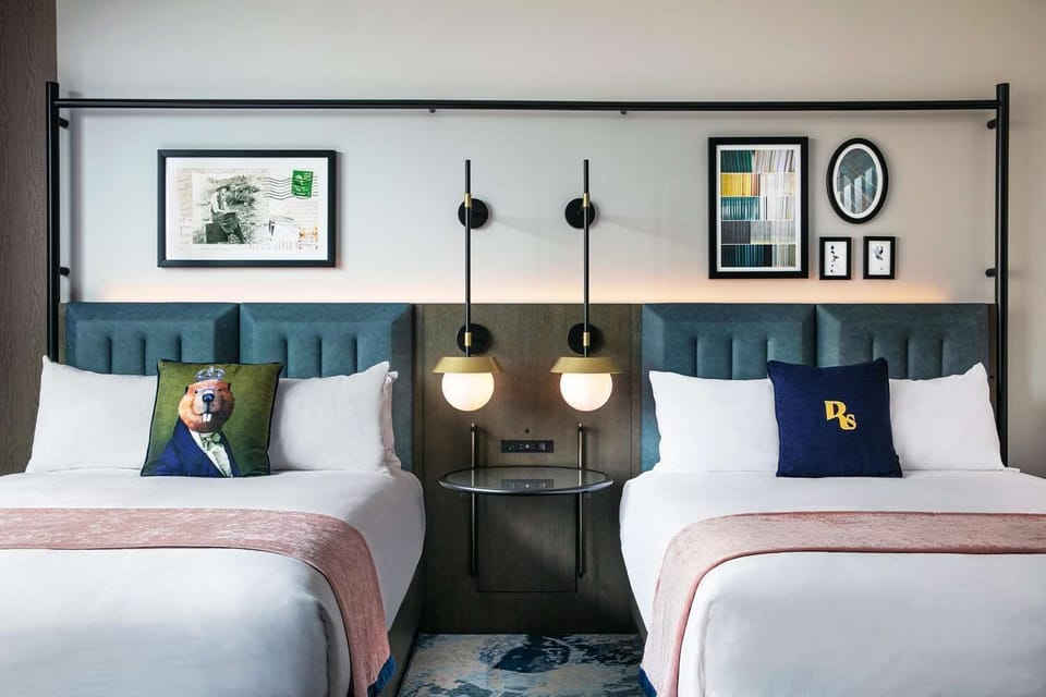 Sink into crisp linens beneath warm, designer bedside lighting.