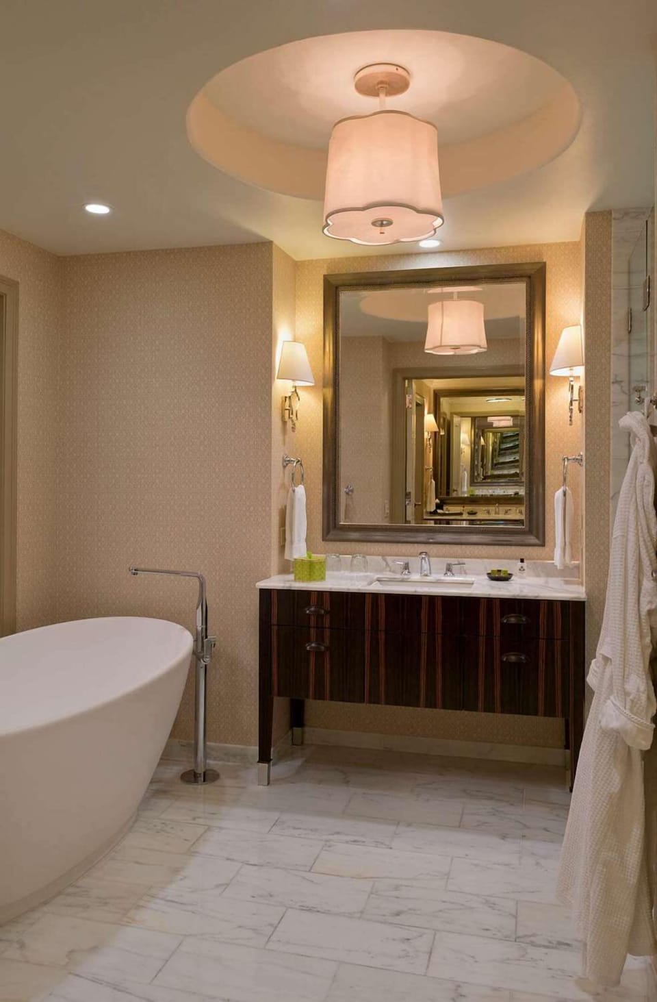 Refresh at a marble vanity with warm, flattering lighting.