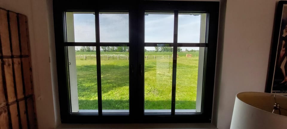 Window view from both bedroom and living room of open fields