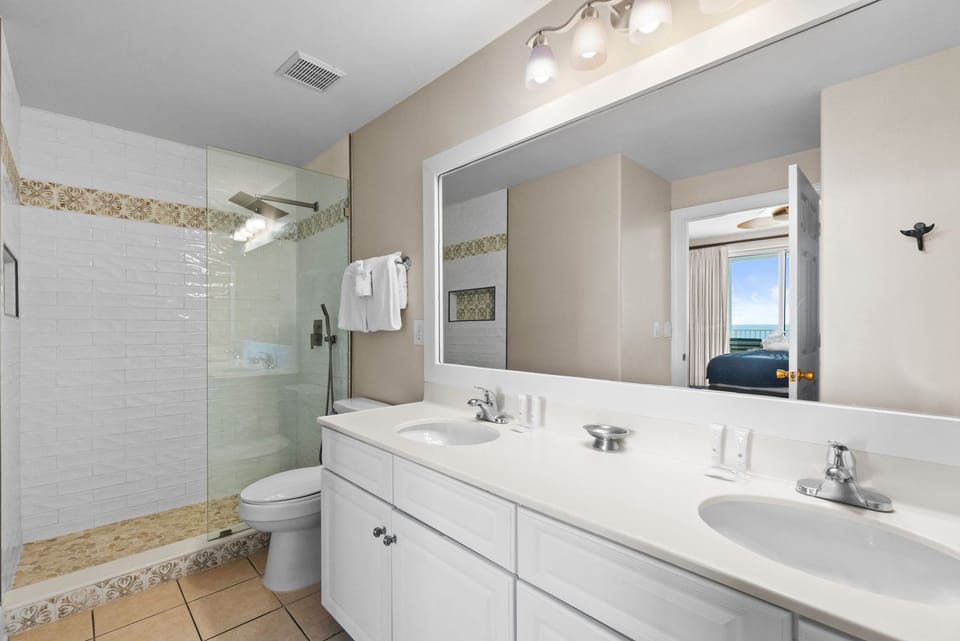 A spacious double vanity provides plenty of room for getting ready.