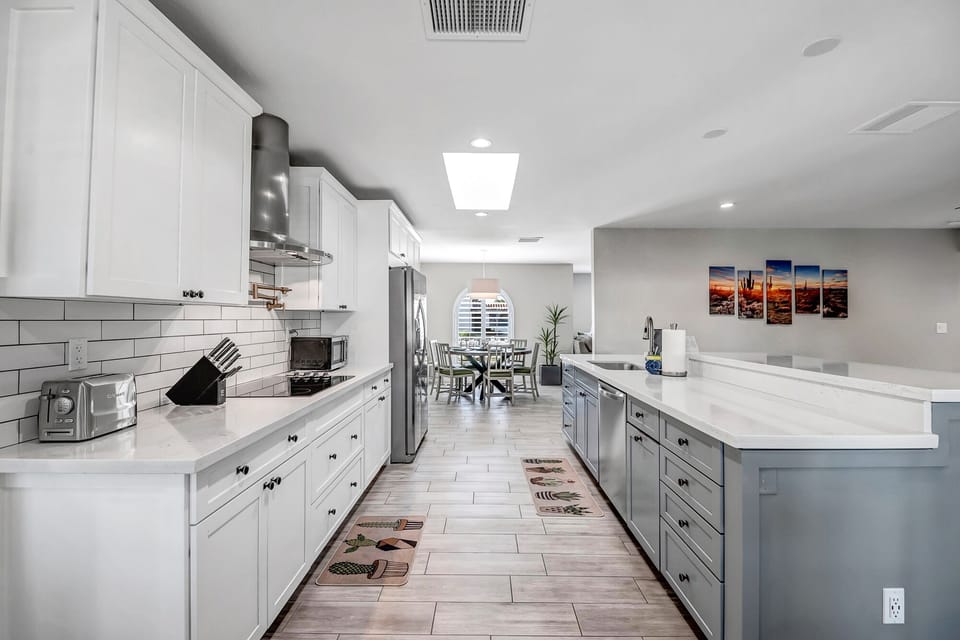Fully Equipped Kitchen with Stainless Steel Appliances And Bar Seating
