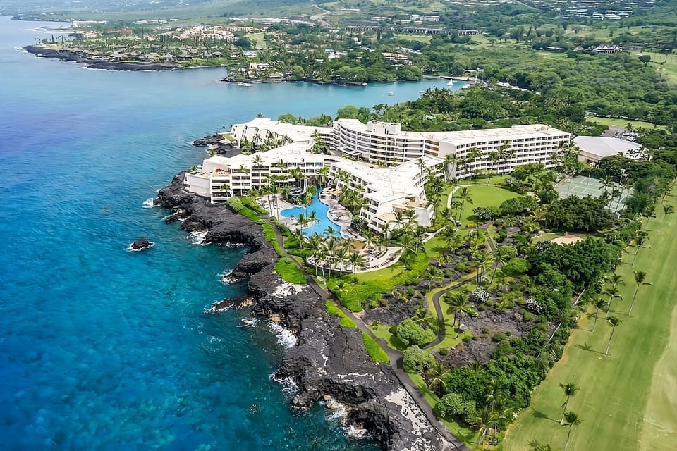 Soar above an oceanfront resort perched on lava-rock shores.
